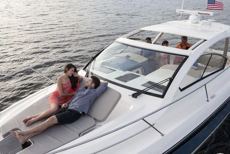 Slide: The Image of Manufacturer Provided Image: 2014 Pursuit SC 365i Sport Coupe with people relaxing on deck. - 4