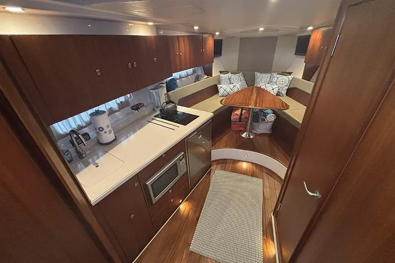 Slide: The Image of 2014 Pursuit SC 365i Sport Coupe interior with kitchen and seating area. - 40