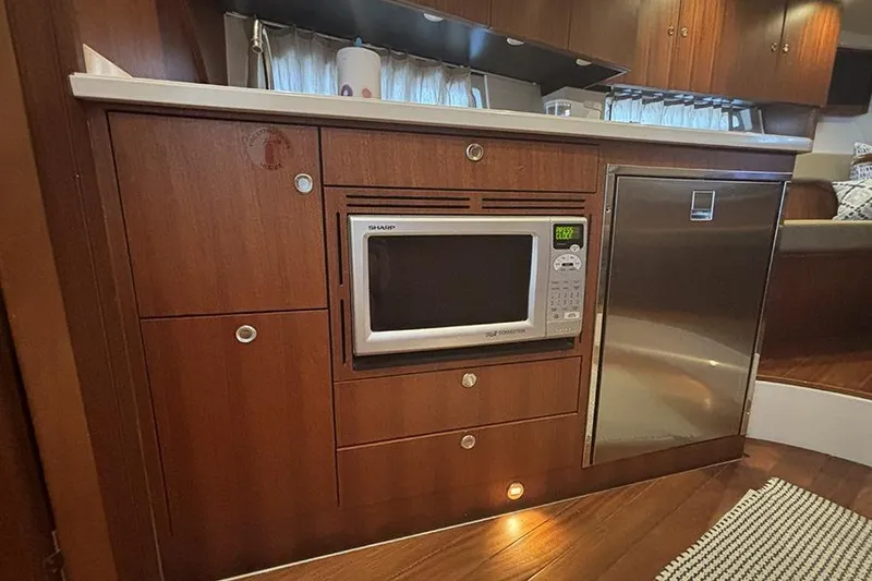 Slide: The Image of 2014 Pursuit SC 365i Sport Coupe interior kitchen with microwave and fridge. - 43