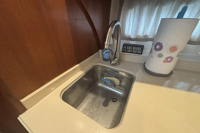 Slide: The Image of 2014 Pursuit SC 365i Sport Coupe kitchen sink with faucet and paper towel holder. - 44