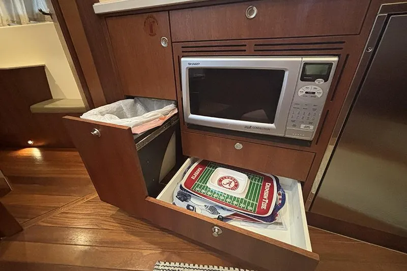 Slide: The Image of 2014 Pursuit SC 365i Sport Coupe interior with microwave and storage drawers. - 46