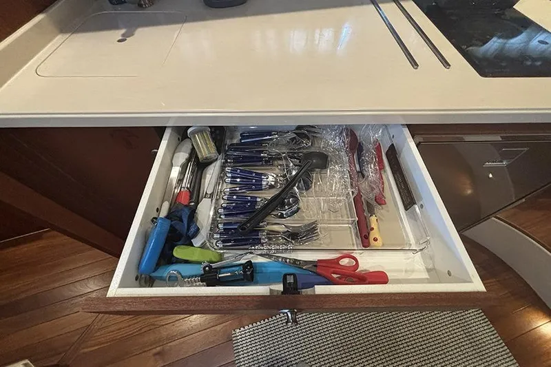 Slide: The Image of Open kitchen drawer with utensils and tools in a 2014 Pursuit SC 365i Sport Coupe. - 47