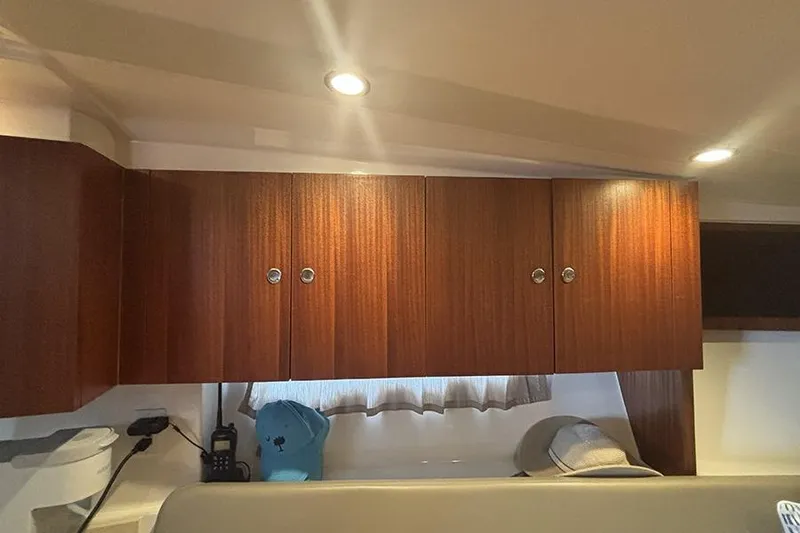 Slide: The Image of Interior of 2014 Pursuit SC 365i Sport Coupe with wooden cabinets and modern lighting. - 49