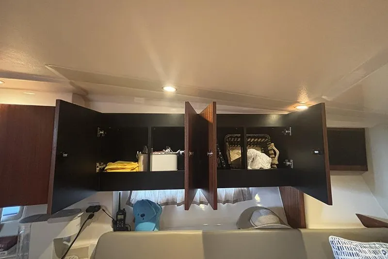 Slide: The Image of Open cabinets in 2014 Pursuit SC 365i Sport Coupe interior, showcasing storage space. - 50