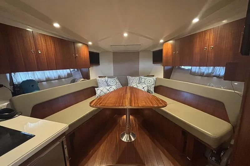 Slide: The Image of Luxurious interior of 2014 Pursuit SC 365i Sport Coupe with wood finishes and seating. - 51