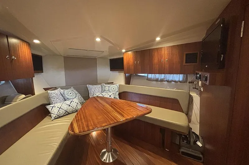 Slide: The Image of Luxurious interior of 2014 Pursuit SC 365i Sport Coupe with wood finishes and cozy seating. - 52