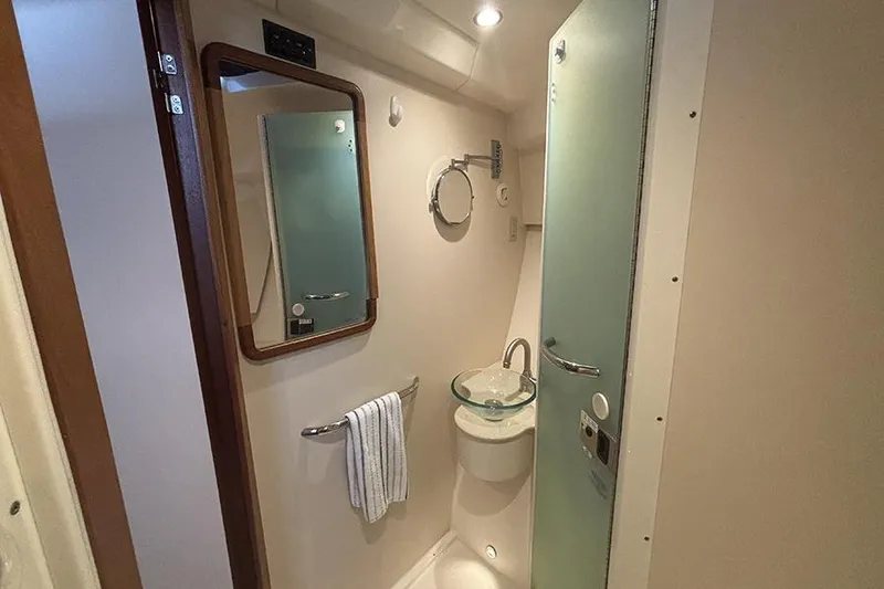 Slide: The Image of Compact bathroom in 2014 Pursuit SC 365i Sport Coupe with modern fixtures and glass sink. - 54