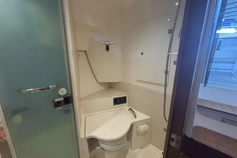 Slide: The Image of 2014 Pursuit SC 365i Sport Coupe bathroom with toilet and shower. - 56