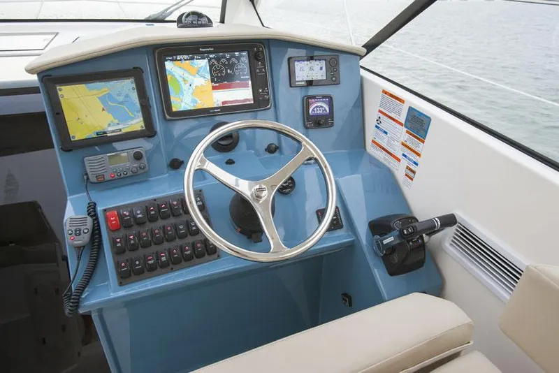 Slide: The Image of Manufacturer Provided Image: Control panel of a 2014 Pursuit SC 365i Sport Coupe boat with navigation screens. - 6