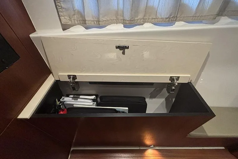 Slide: The Image of Storage compartment inside 2014 Pursuit SC 365i Sport Coupe, featuring organized documents and accessories. - 60