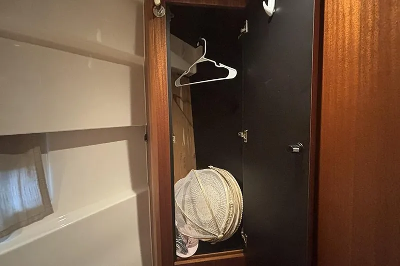 Slide: The Image of Closet interior on 2014 Pursuit SC 365i Sport Coupe with hangers and storage basket. - 64