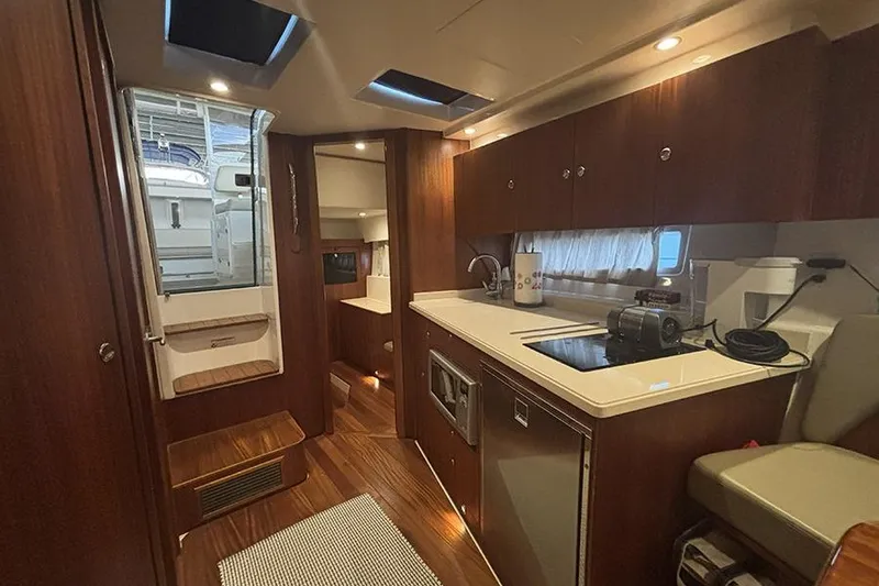 Slide: The Image of Luxurious interior of 2014 Pursuit SC 365i Sport Coupe yacht with modern kitchen amenities. - 65