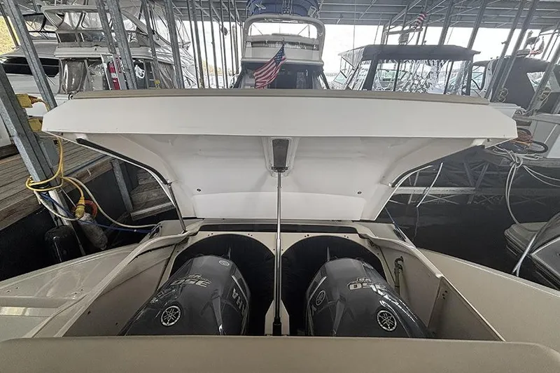 Slide: The Image of 2014 Pursuit SC 365i Sport Coupe with open engine hatch in marina. - 68