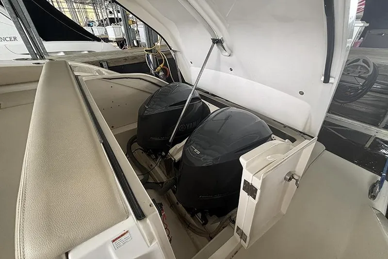 Slide: The Image of 2014 Pursuit SC 365i Sport Coupe with dual Yamaha engines in open engine compartment. - 69