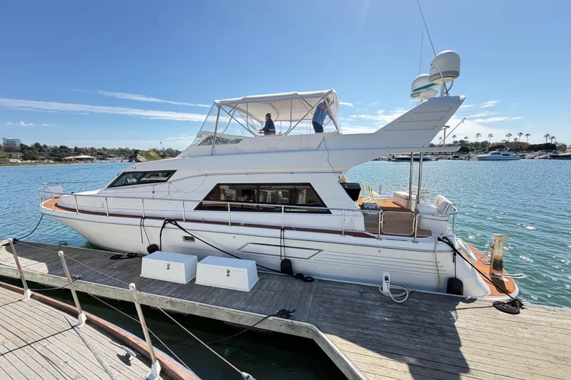 The Image of 2001 Tarrab Motor Yacht docked at a marina under clear blue skies. - 0