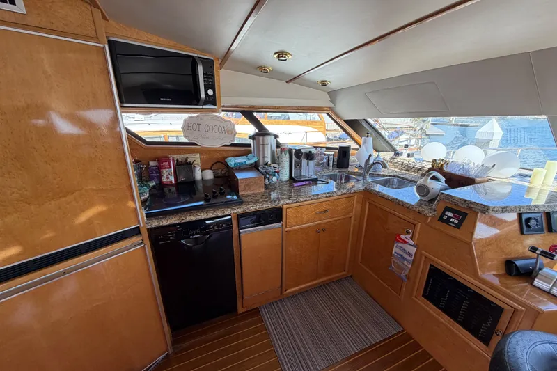 Slide: The Image of Luxurious 2001 Tarrab Motor Yacht kitchen with modern appliances and elegant wood finish. - 10