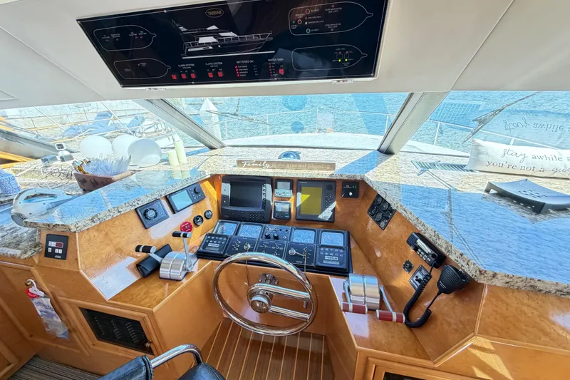 Slide: The Image of Helm of 2001 Tarrab Motor Yacht with modern navigation controls and panoramic view. - 11
