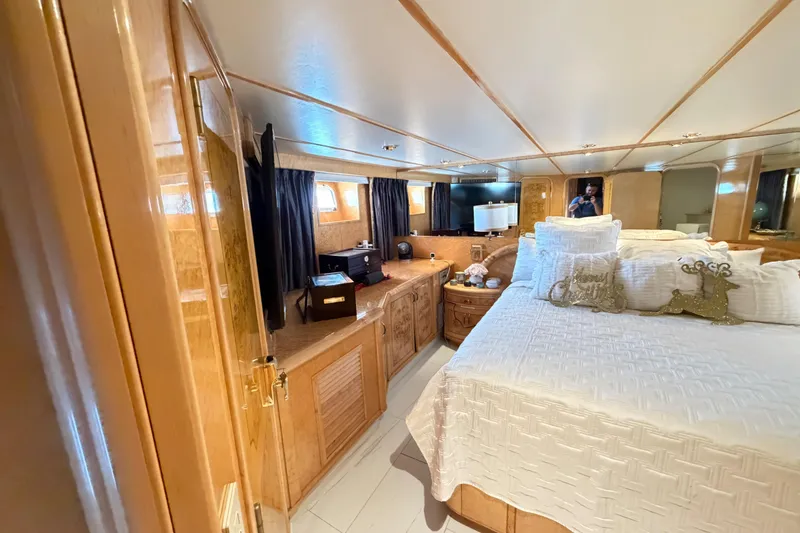 Slide: The Image of Luxurious 2001 Tarrab Motor Yacht bedroom with elegant wood finishes and plush bedding. - 13