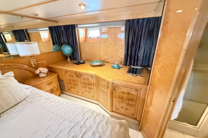 Slide: The Image of Luxurious 2001 Tarrab Motor Yacht bedroom with elegant wood cabinetry and decor. - 15