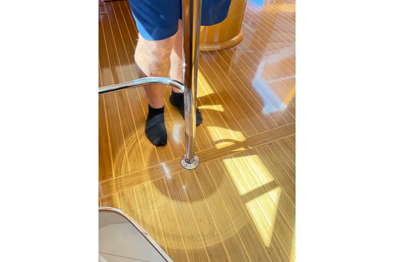 Slide: The Image of Polished wooden floor on 2001 Tarrab Motor Yacht with person in black socks. - 17
