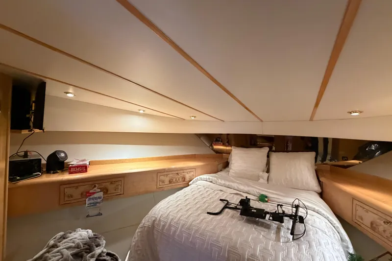 Slide: The Image of Cozy bedroom interior of 2001 Tarrab Motor Yacht with elegant wood accents and soft lighting. - 24