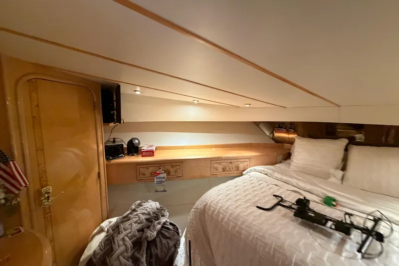 Slide: The Image of Luxurious 2001 Tarrab Motor Yacht bedroom with cozy bedding and elegant wood finishes. - 26