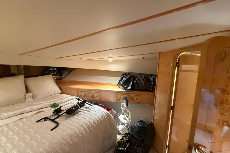 Slide: The Image of Luxurious 2001 Tarrab Motor Yacht bedroom with elegant wood accents and cozy bedding. - 27