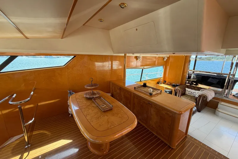 Slide: The Image of Luxurious interior of a 2001 Tarrab Motor Yacht with elegant wood finishes and scenic ocean view. - 29