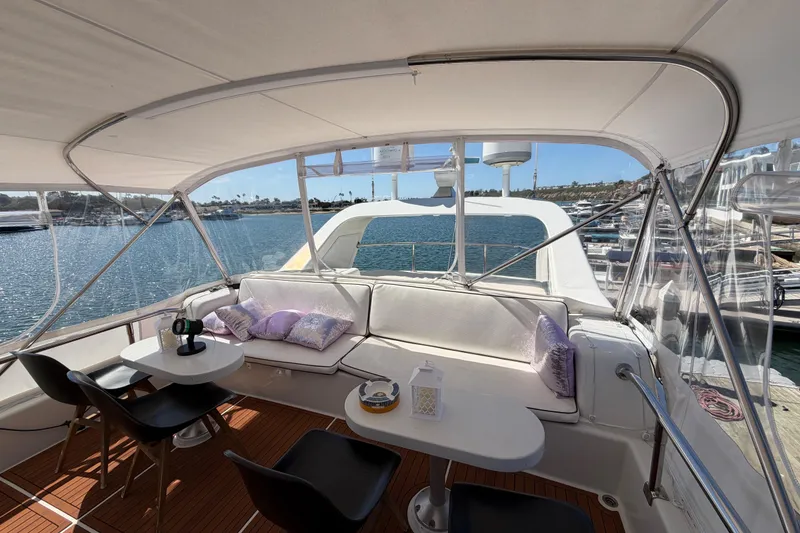 Slide: The Image of Luxurious 2001 Tarrab Motor Yacht interior with elegant seating and scenic marina view. - 30