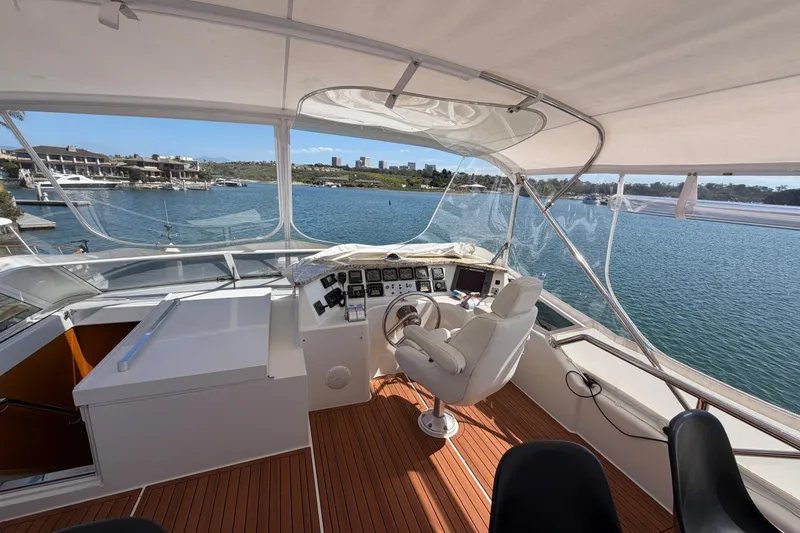 Slide: The Image of Luxurious 2001 Tarrab Motor Yacht helm with scenic waterfront view. - 31