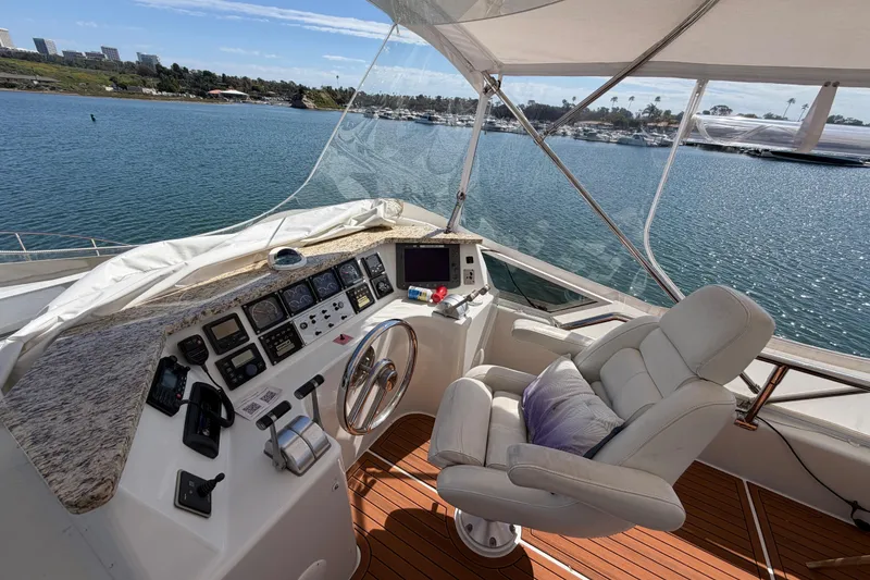 Slide: The Image of Luxurious 2001 Tarrab Motor Yacht helm with plush seating and scenic water view. - 33