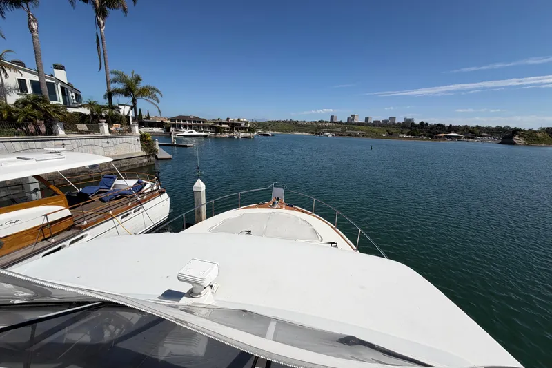 Slide: The Image of Tarrab 2001 motor yacht docked in scenic marina with waterfront homes and clear blue sky. - 35