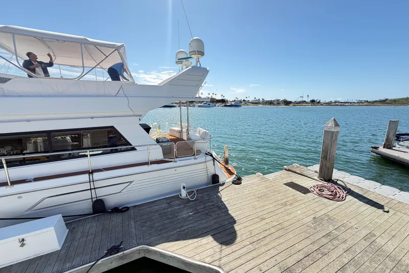 Slide: The Image of Tarrab 2001 motor yacht docked at a sunny marina, with clear blue water. - 38