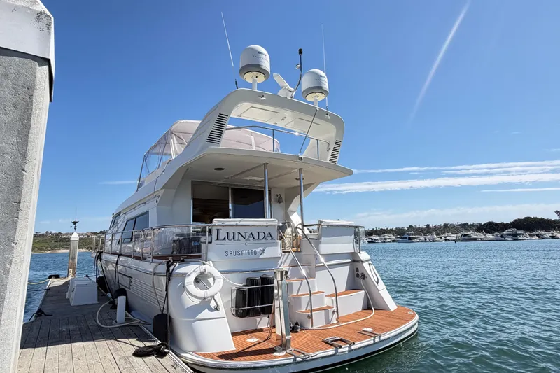 Slide: The Image of Luxury 2001 Tarrab Motor Yacht docked at marina under clear blue sky. - 40
