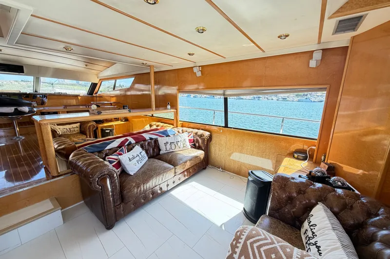 Slide: The Image of Luxurious 2001 Tarrab Motor Yacht interior with leather seating and ocean view. - 42