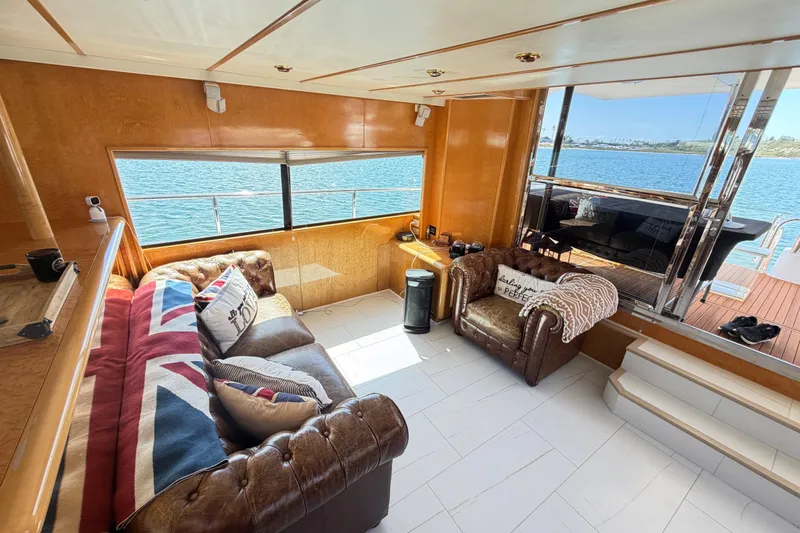 Slide: The Image of Luxurious 2001 Tarrab Motor Yacht interior with plush seating and scenic ocean view. - 43