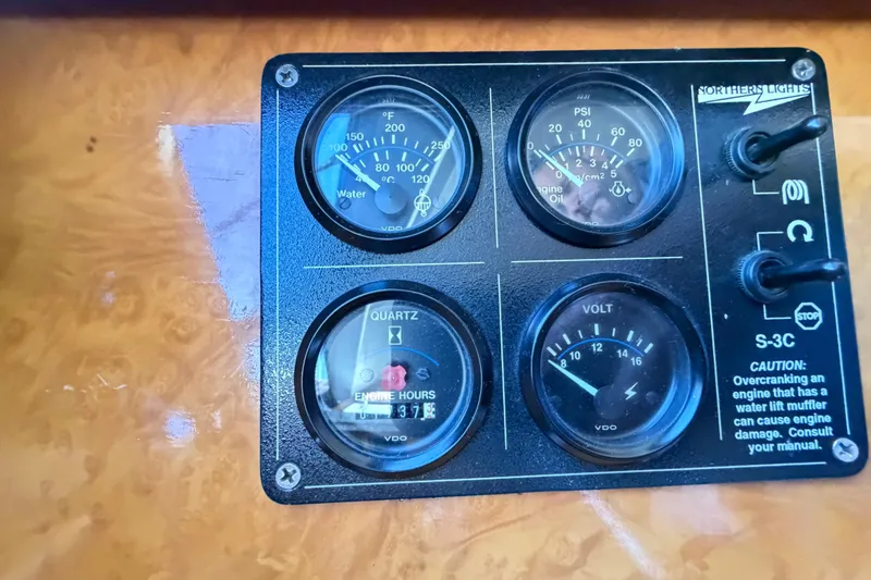 Slide: The Image of Control panel of a 2001 Tarrab Motor Yacht with gauges and switches. - 44