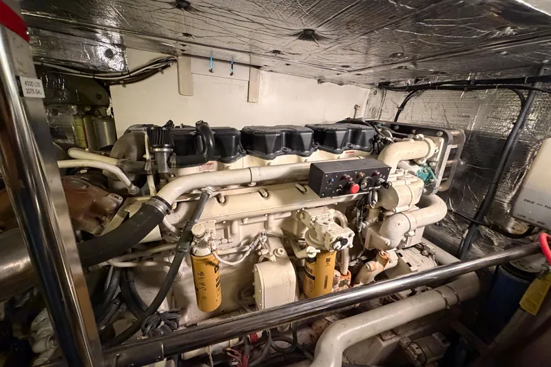 Slide: The Image of Engine room of a 2001 Tarrab Motor Yacht, showcasing complex machinery and components. - 47