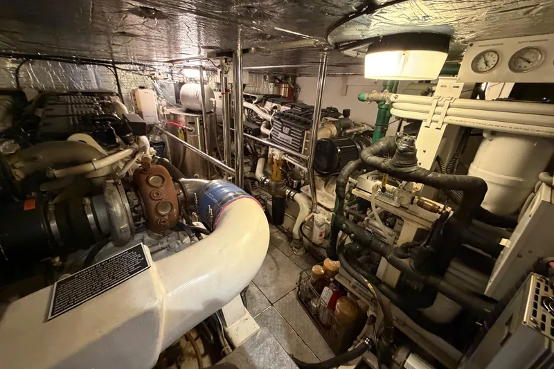 Slide: The Image of Engine room of a 2001 Tarrab Motor Yacht, showcasing complex machinery and equipment. - 49
