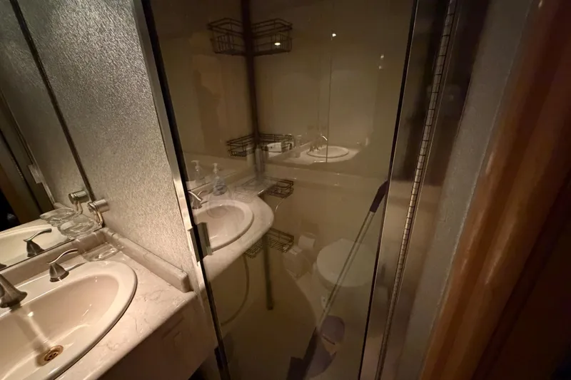 Slide: The Image of Luxurious bathroom interior on a 2001 Tarrab Motor Yacht, featuring a sleek sink and glass shower. - 5