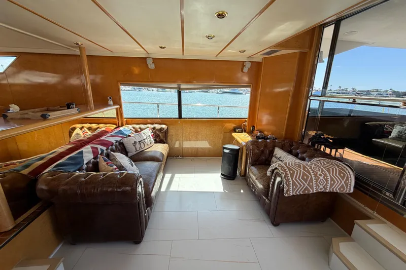 Slide: The Image of Luxurious 2001 Tarrab Motor Yacht interior with leather sofas and scenic ocean view. - 6
