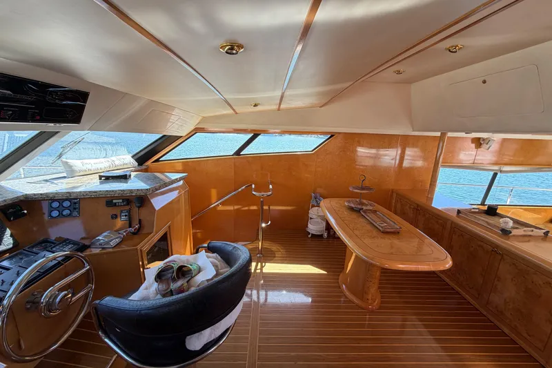 Slide: The Image of Luxurious 2001 Tarrab motor yacht interior with polished wood and panoramic windows. - 8