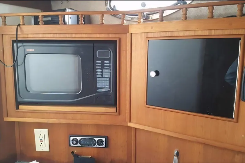 Slide: The Image of 2004 Carolina Classic 28 interior with microwave and storage cabinet. - 12
