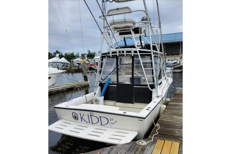 Slide: The Image of 2004 Carolina Classic 28 boat docked at marina, rear view with fishing tower. - 7