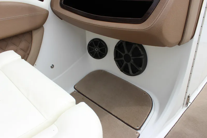 Slide: The Image of Interior of 2012 Cobalt A25 boat with speakers and cushioned seating. - 11