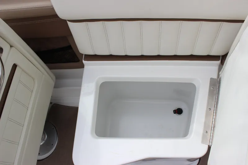 Slide: The Image of Interior storage compartment of a 2012 Cobalt A25 boat with white upholstery. - 13