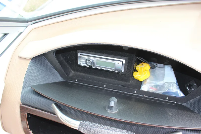 Slide: The Image of Glove compartment of 2012 Cobalt A25 boat with stereo system and accessories. - 20