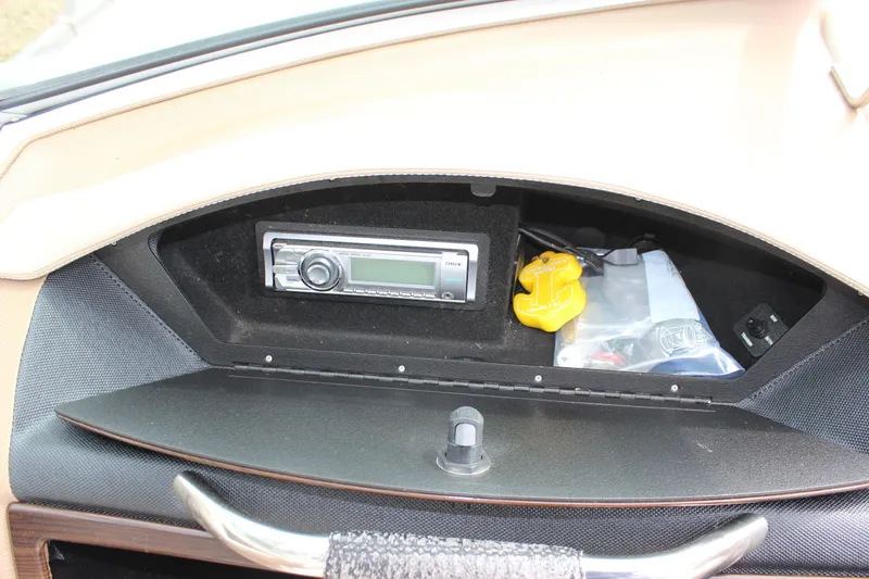 Slide: The Image of Dashboard compartment of a 2012 Cobalt A25 with stereo system and storage items. - 21