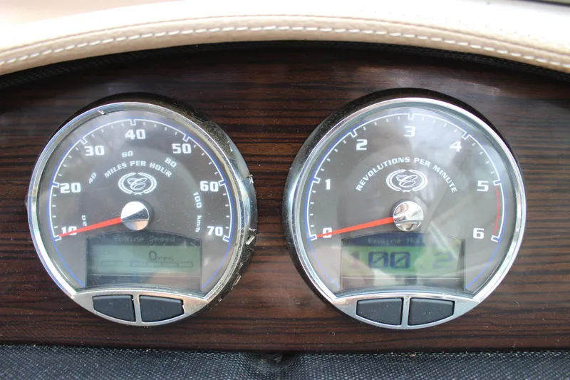 Slide: The Image of Dashboard of a 2012 Cobalt A25 boat showing speedometer and tachometer. - 22