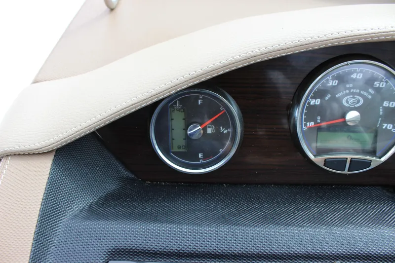 Slide: The Image of Dashboard gauges of a 2012 Cobalt A25 boat, featuring speedometer and fuel indicators. - 23